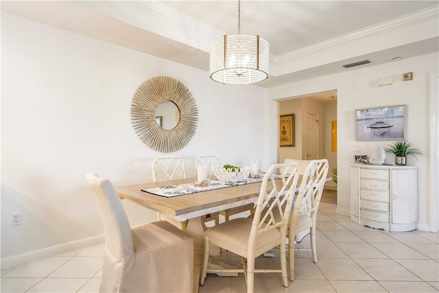 dining space with light tile patterned floors, baseboards, visible vents, and crown molding