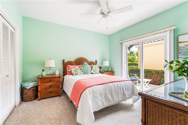 carpeted bedroom featuring access to outside, a ceiling fan, and a closet