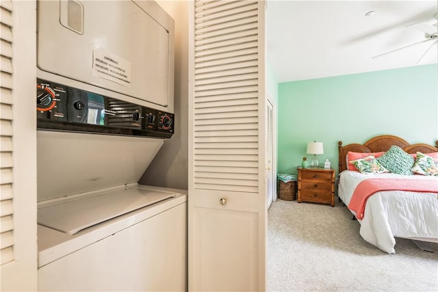 clothes washing area with stacked washer and dryer, laundry area, ceiling fan, and carpet floors