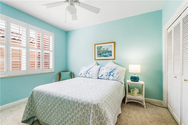 bedroom featuring a closet, carpet flooring, a ceiling fan, and baseboards