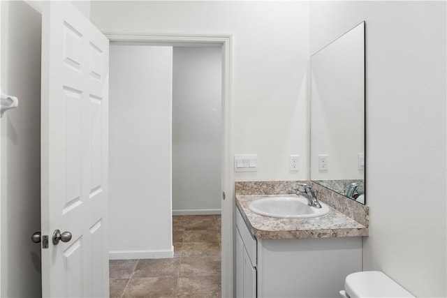 2025 Amazon Way SW, Vero Beach, FL 32962 - bathroom featuring toilet, vanity, and baseboards