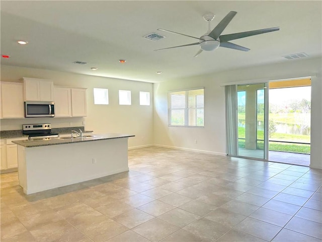 kitchen with stainless steel appliances, visible vents, and white cabinets