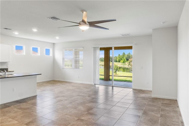 2025 Amazon Way SW, Vero Beach, FL 32962 - unfurnished living room with a ceiling fan, baseboards, recessed lighting, and a sink