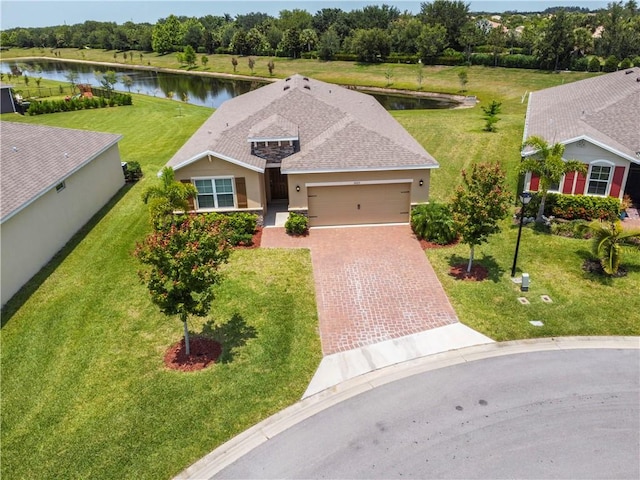 2025 Amazon Way SW, Vero Beach, FL 32962 - ranch-style house with driveway, a water view, a garage, and stucco siding