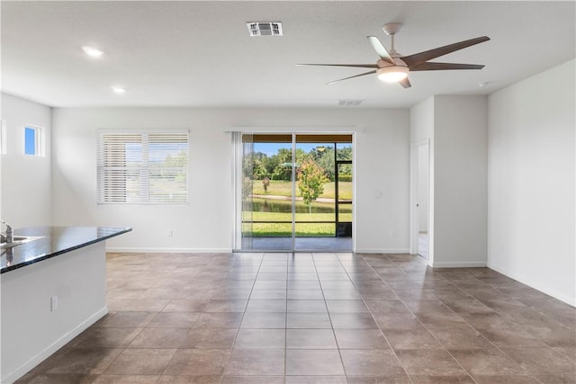 2025 Amazon Way SW, Vero Beach, FL 32962 - empty room with healthy amount of natural light, ceiling fan, tile patterned floors, recessed lighting, and baseboards