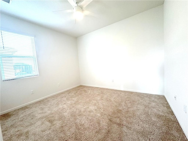 spare room featuring carpet flooring and ceiling fan