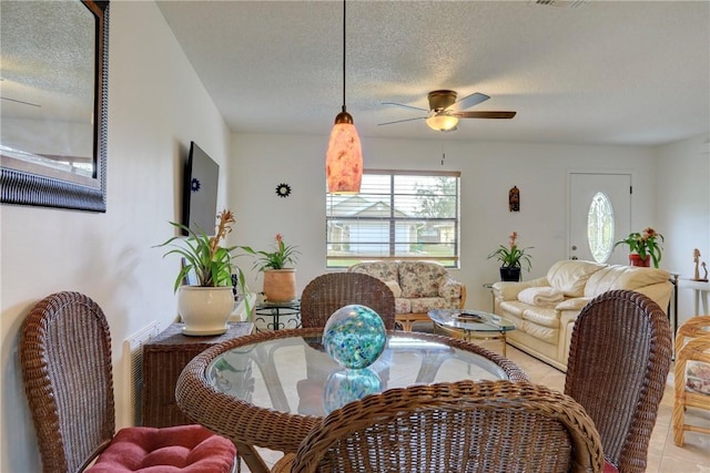 living area featuring a textured ceiling and a ceiling fan