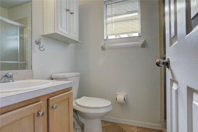 full bathroom featuring baseboards, toilet, vanity, tile patterned flooring, and a stall shower