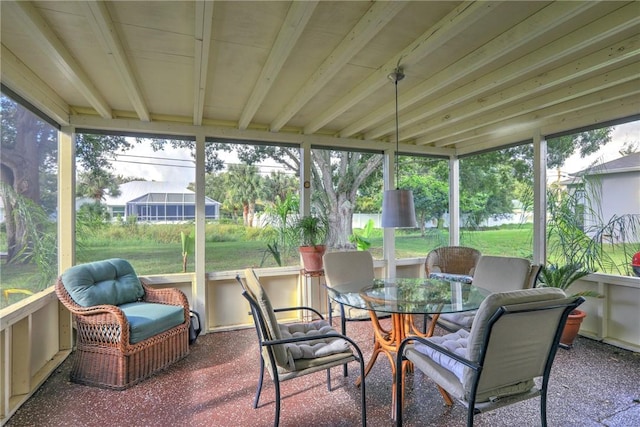 sunroom featuring outdoor dining area and a healthy amount of sunlight