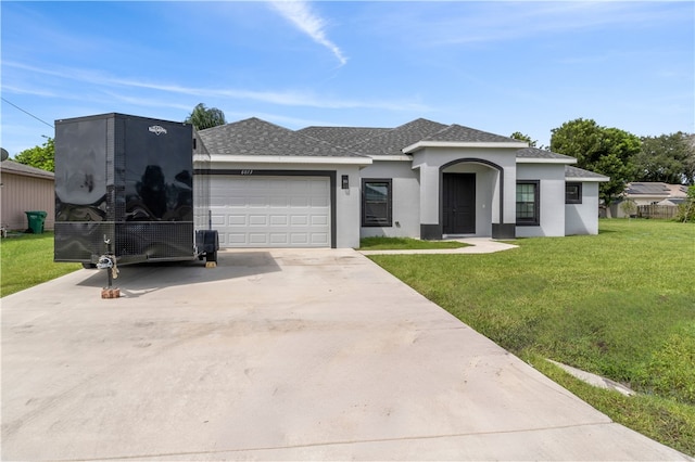 view of front of property featuring a front lawn and a garage