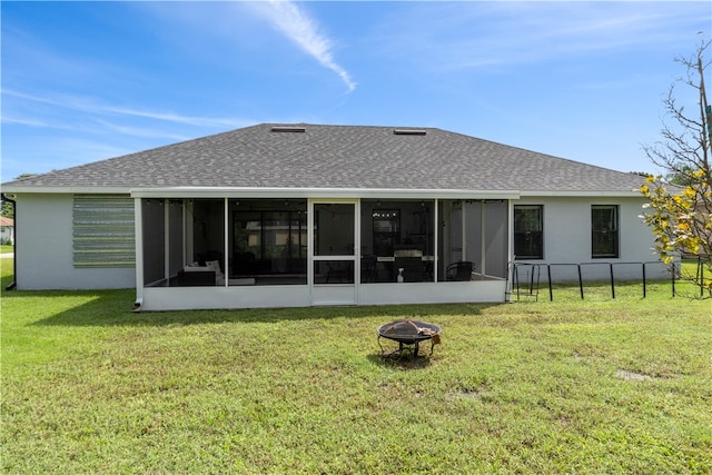 back of house with a sunroom and a yard