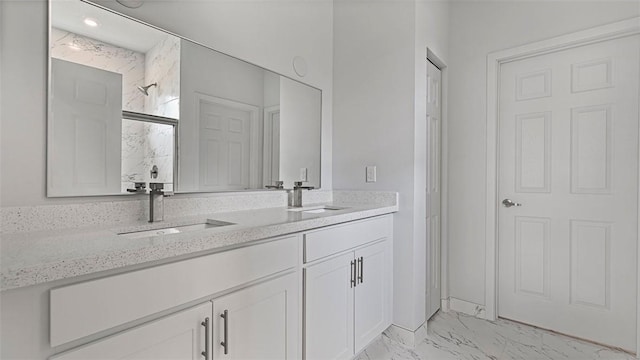 bathroom with vanity and a shower