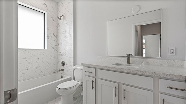 full bathroom with tiled shower / bath, vanity, and toilet