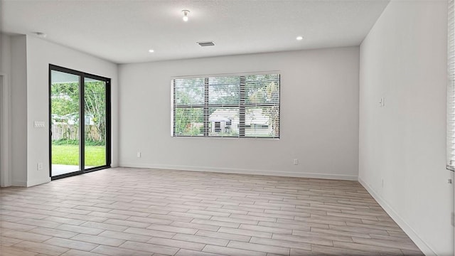 unfurnished room with light wood-type flooring