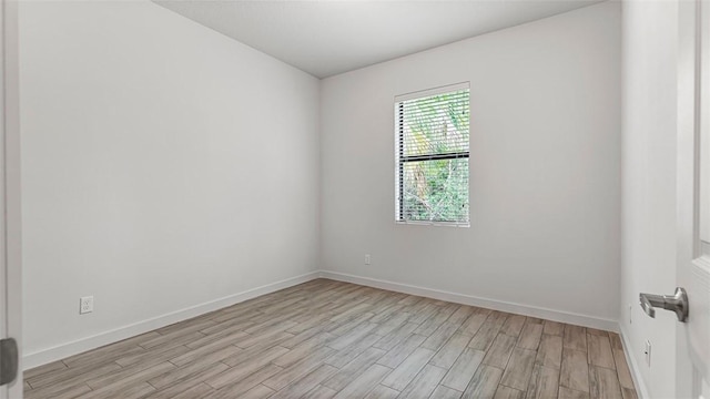 empty room with light hardwood / wood-style flooring