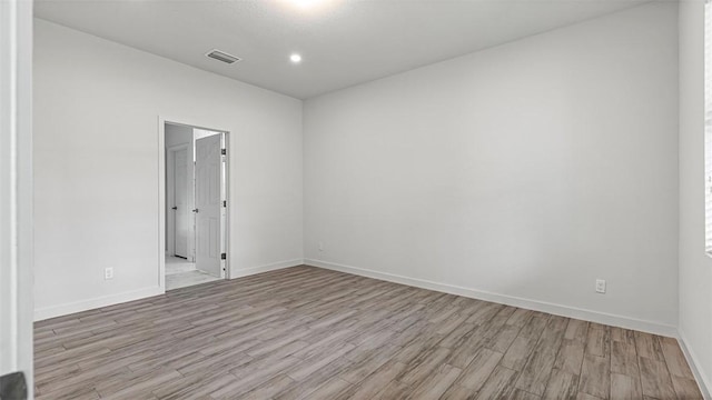 unfurnished room featuring light hardwood / wood-style floors