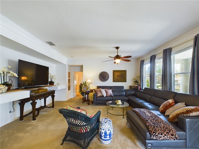 living room with ceiling fan, a textured ceiling, light carpet, and crown molding