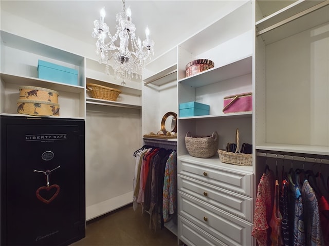 walk in closet featuring a chandelier