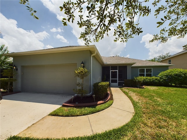 ranch-style home with a front lawn and a garage