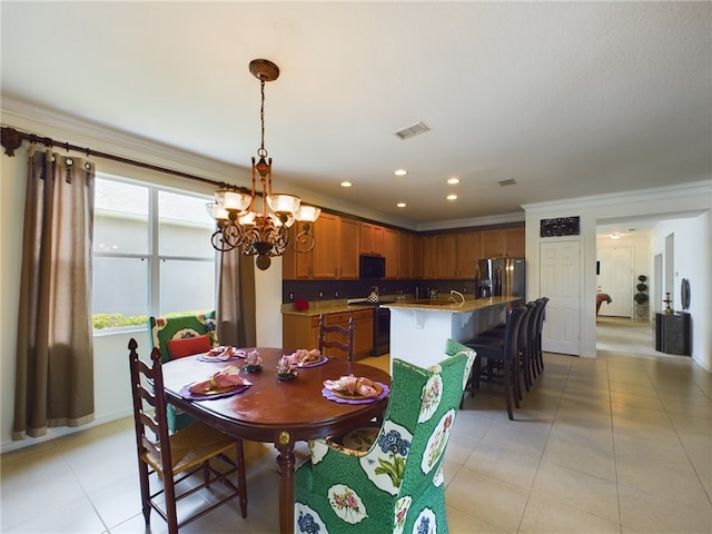 dining space featuring a chandelier, light tile patterned floors, and crown molding