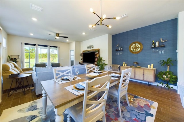 dining room with ceiling fan with notable chandelier