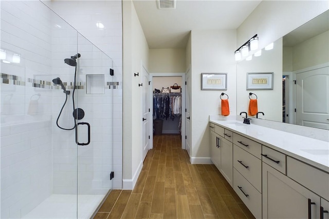 bathroom featuring vanity and a shower with shower door