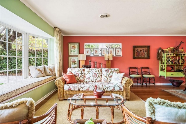 living room with crown molding and wood-type flooring