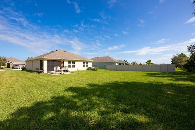 back of property featuring a lawn and a patio area