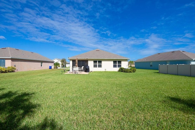 back of house featuring a yard and a patio