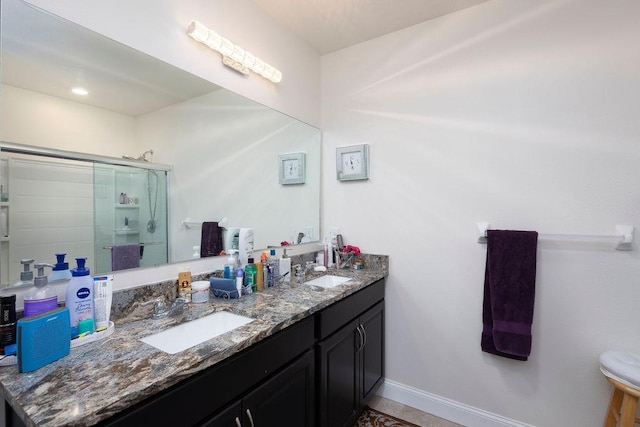 bathroom featuring vanity and an enclosed shower