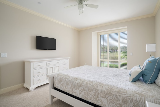 carpeted bedroom featuring ceiling fan and ornamental molding