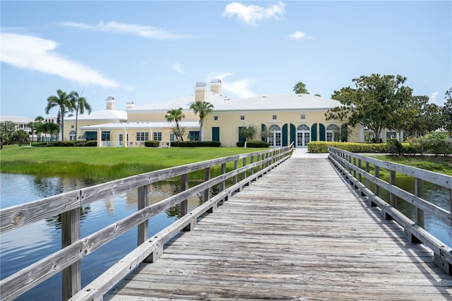 view of dock featuring a yard and a water view