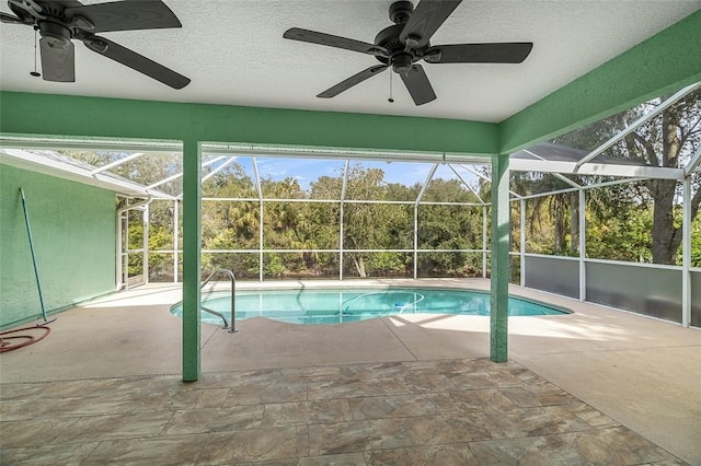 view of pool featuring a patio area, ceiling fan, and glass enclosure