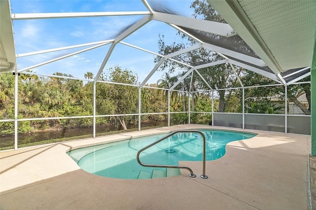 view of pool featuring a patio area and glass enclosure