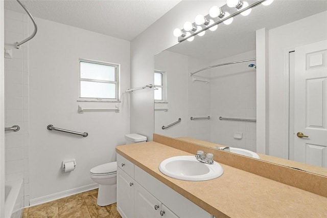 bathroom with vanity, a textured ceiling, and toilet