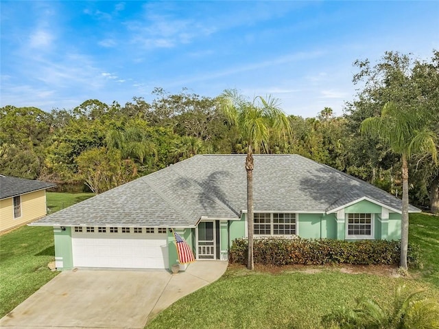 ranch-style home with a garage and a front lawn