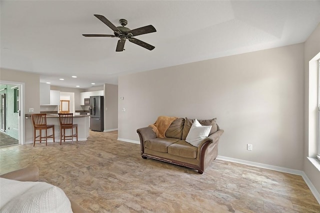 living room with a wealth of natural light and ceiling fan