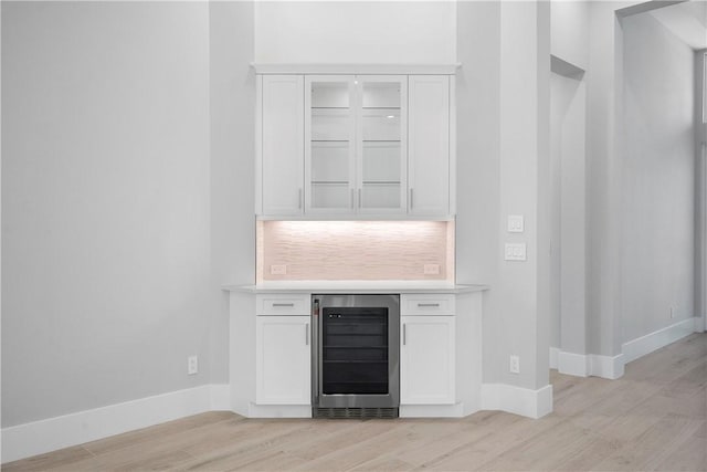 129 Strand Dr, Vero Beach, FL 32963 - bar featuring baseboards, light wood finished floors, and wine cooler