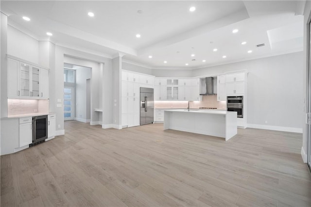 129 Strand Dr, Vero Beach, FL 32963 - kitchen featuring ornamental molding, beverage cooler, wall chimney range hood, tasteful backsplash, and stainless steel appliances