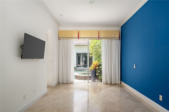 8455 Bay Leaf Ln Unit 11, Vero Beach, FL 32963 - empty room featuring baseboards, ornamental molding, and arched walkways