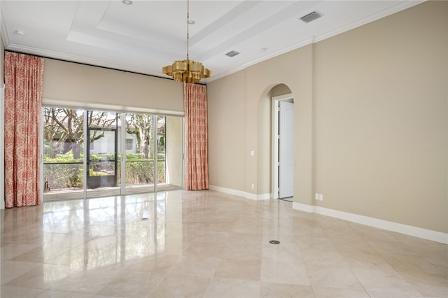 8455 Bay Leaf Ln Unit 11, Vero Beach, FL 32963 - spare room with arched walkways, a raised ceiling, a chandelier, crown molding, and baseboards