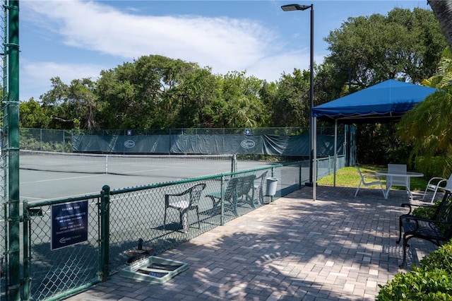 8455 Bay Leaf Ln Unit 11, Vero Beach, FL 32963 - view of tennis court with fence