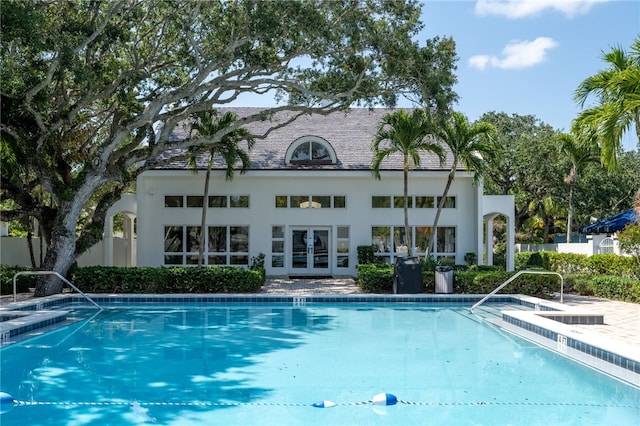 8455 Bay Leaf Ln Unit 11, Vero Beach, FL 32963 - rear view of house featuring french doors, a community pool, stucco siding, and fence