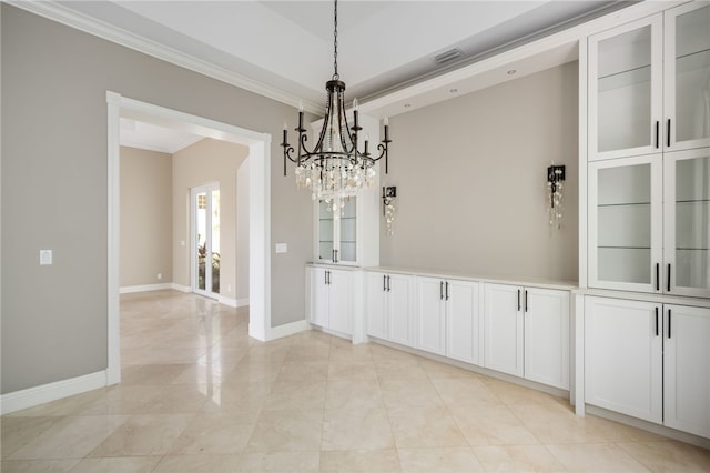 8455 Bay Leaf Ln Unit 11, Vero Beach, FL 32963 - unfurnished dining area with crown molding, a chandelier, and baseboards