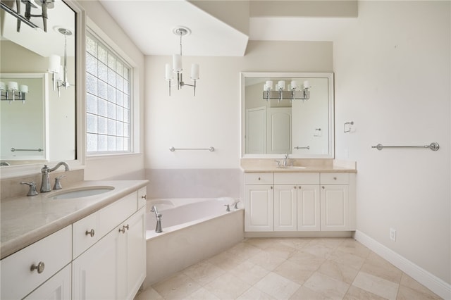 8455 Bay Leaf Ln Unit 11, Vero Beach, FL 32963 - bathroom with two vanities, a bath, and a chandelier