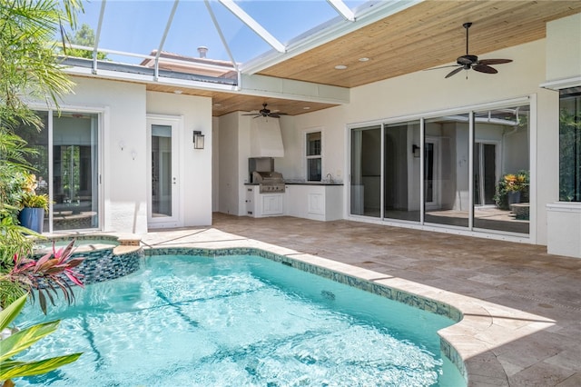 8455 Bay Leaf Ln Unit 11, Vero Beach, FL 32963 - view of swimming pool featuring an outdoor kitchen, a ceiling fan, a grill, a patio area, and glass enclosure