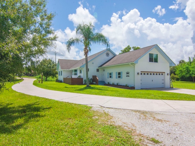 single story home featuring a garage and a front lawn