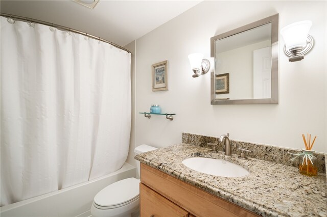 full bathroom featuring vanity, toilet, and shower / tub combo