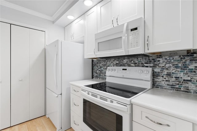 kitchen featuring tasteful backsplash, white appliances, white cabinets, crown molding, and light countertops