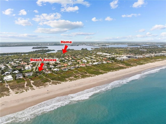 aerial view featuring a water view and a beach view